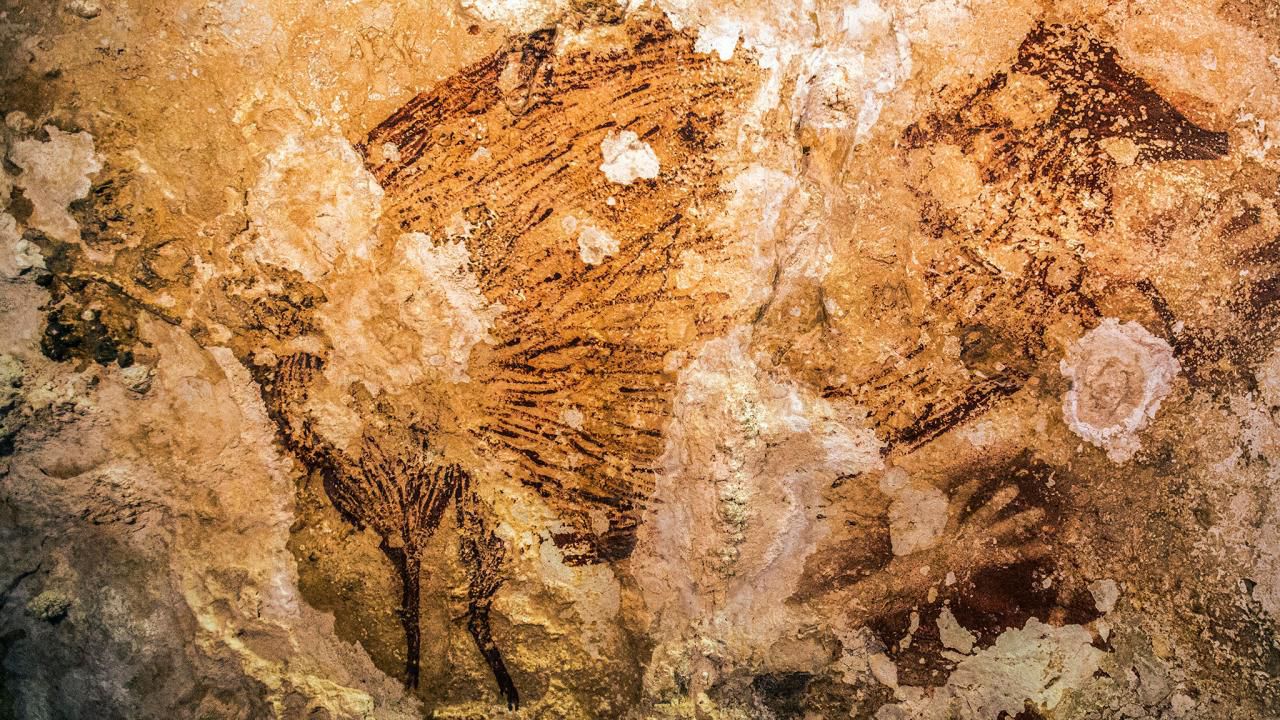 A cave painting in Sulawesi,Indonesia is the oldest known artwork made by humans. Image via Kinez Riza.