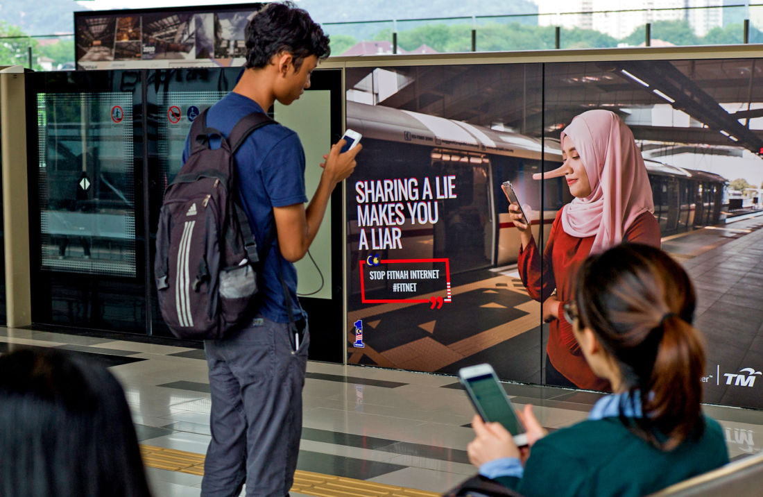 Singapore fake news law in action, Facebook post amended with government statement. Image via Agence France-Presse.
